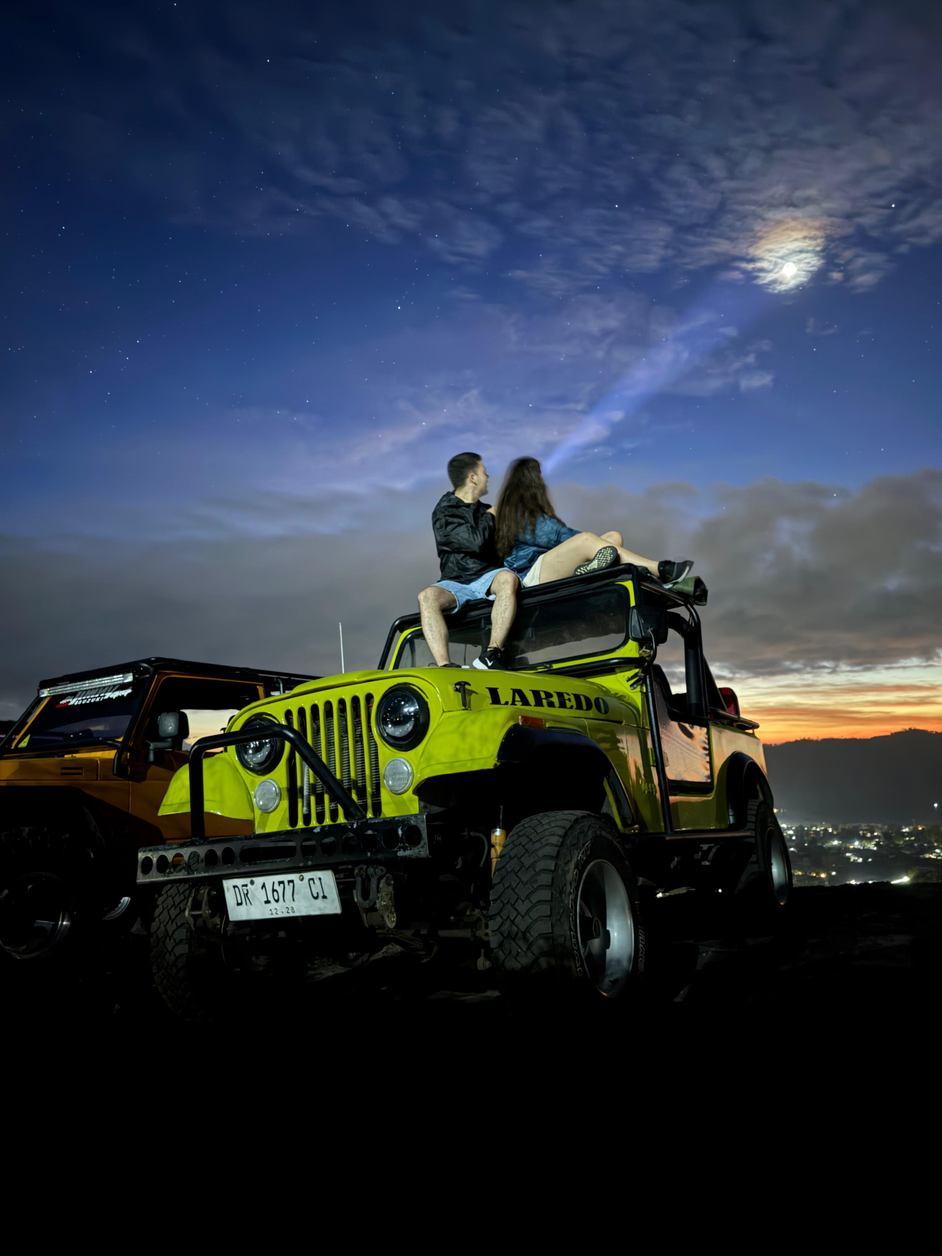 Jeep tour travelers under moonlight